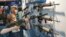 A young man, who chose not to give his name, sizes-up an assault style rifle during the National Rifle Association's annual convention in Houston, Texas, May 3, 2013. 