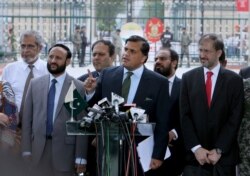Pakistan Foreign Ministry spokesman Mohammad Faisal, center, briefs the media before the meeting with Indian officials at Wagah border, near Lahore, Pakistan, Sunday, July 14, 2019.