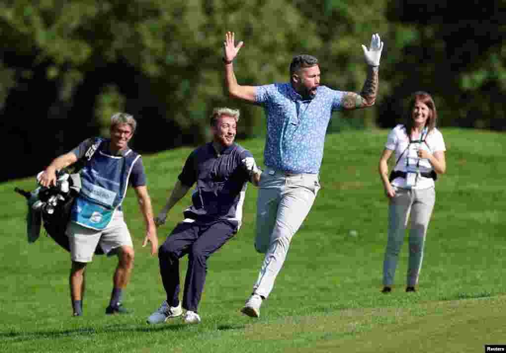 Former English boxer Tony Bellew celebrates an albatross during the BMW PGA Championship at Wentworth Club, Virginia Water, Britain.