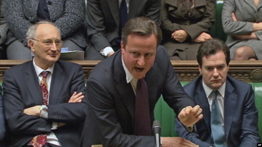 Britain's Prime Minister David Cameron (C) is flanked by Chancellor of the Exchequer George Osborne (R) and Leader of the House of Commons George Young during a parliamentary debate on last week's European Union summit, in London, December 12, 2011.
