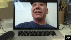 Chinese dissident Zhang Xiangzhong is seen on a computer screen during an interview via videoconference April 17, 2017, in Taipei, Taiwan.