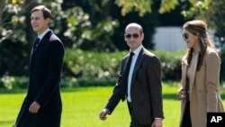 FILE - Senior Adviser to the President Stephen Miller, center, Senior Adviser to the President Jared Kushner and counselor to the President Hope Hicks walk to board Marine One at the White House, Sept. 30, 2020.