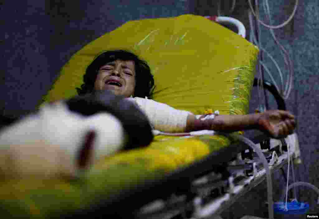 Manea Abdul-Latif Marzouq, 12, cries as he lies on a stretcher at a hospital in Sana&#39;a after he was injured in an airstrike in the northern province of al-Jawf, Yemen, July 15, 2020.