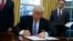 FILE - President Donald Trump signs an executive order in the Oval Office of the White House, Jan. 23, 2017. Trump is expected to sign several executive orders on energy and the environment this week.