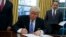 President Donald Trump signs an executive order to withdraw the U.S. from the 12-nation Trans-Pacific Partnership trade pact agreed to under the Obama administration, Jan. 23, 2017, in the Oval Office of the White House.
