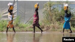 ২০১৯ সালের ১লা নভেম্বর, সুদানের গুমুরুকে বন্যার জলের মধ্যে বাস্তুচ্যুত বাসিন্দাদের ত্রাণ সামগ্রী বহন করতে দেখা যাচ্ছে।