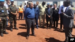 FILE - U.N. Secretary-General Antonio Guterres, center, listens to U.N. staff in Bangui, Central African Republic, Oct. 25, 2017. Guterres, visiting one of the most volatile towns in CAR, thanked peacekeepers for their "extraordinary courage." Fighting had surged recently in Bangassou. 