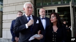 Roger Stone, left, with his wife Nydia Stone, leaves federal court in Washington, Nov. 15, 2019. 