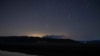 FILE - Stars move on the night sky during the Perseid meteor shower in the Pineios Lake near the village of Velanidi, Peloponnese, Greece, Aug. 13, 2020.