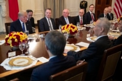 FILE - President Donald Trump and Chinese Vice Premier Liu He have lunch after signing the 'Phase 1' U.S.-China trade agreement, in the State Dining Room of the White House, Jan. 15, 2020, in Washington.