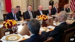 President Donald Trump and Chinese Vice Premier Liu He have lunch after signing the 'Phase 1' U.S.-China trade agreement, in the State Dining Room of the White House, Jan. 15, 2020, in Washington.