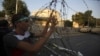 A member of the Muslim Brotherhood and supporter of ousted Egyptian President Mohamed Morsi holds onto barbed wire as he shouts slogans against the military and interior ministry near El-Thadiya presidential palace in Cairo, Sept. 20, 2013.