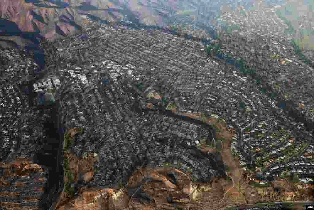 This aerial photo shows homes and businesses reduced to rubble by the Palisades Fire in the Pacific Palisades neighborhood of Los Angeles, California, Jan. 10, 2025. 