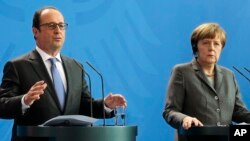 German Chancellor Angela Merkel and French President Francois Hollande talk to reporters after meeting in Berlin, March 31, 2015.