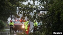 Crews with the Charleston Fire Department clear a fallen tree during Hurricane Dorian in Charleston, South Carolina, Sept. 5, 2019.