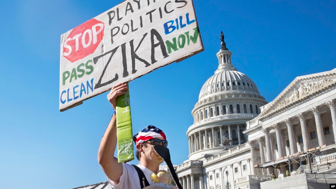 FILE - Wearing a homemade mosquito costume, an expectant father from Washington who asked not to be named, protests the lack of Congressional approval to fund a federal response to the Zika virus, Sept. 14, 2016, on Capitol Hill in Washington. 