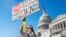 FILE - Wearing a homemade mosquito costume, an expectant father from Washington who asked not to be named, protests the lack of Congressional approval to fund a federal response to the Zika virus, Sept. 14, 2016, on Capitol Hill in Washington. 
