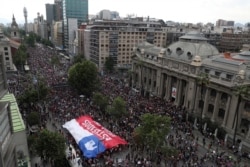 Anti-government demonstrators march in Santiago, Chile, Oct. 25, 2019.