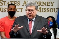 FILE - Attorney General William Barr talks to the media during a news conference about Operation Legend, a federal task force formed to fight violent crime in several cities, in Kansas City, Mo., Aug. 19, 2020.