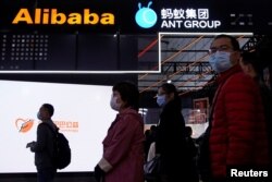 FILE - Signs of Alibaba Group and Ant Group are seen during the World Internet Conference in Wuzhen, Zhejiang province, China, Nov. 23, 2020.