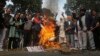 Sikh protestors burn effigies of congress party leaders Sajjan Kumar and Kamal Nath during a protest in New Delhi, India, Monday, Dec. 17, 2018.