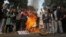 Sikh protestors burn effigies of congress party leaders Sajjan Kumar and Kamal Nath during a protest in New Delhi, India, Monday, Dec. 17, 2018.