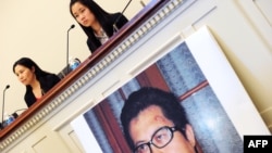 FILE - Zhang Qing, left, wife of Chinese human rights activist Guo Feixiong, and daughter Yang Tianjiao speak at a press conference before a hearing of a House Foreign Affairs Committee subcommittee in Washington, D.C., October 29, 2013.