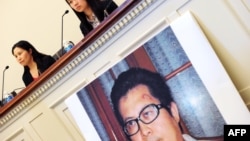 FILE - Zhang Qing (l) wife of Chinese human rights activist Guo Feixiong, and daughter Yang Tianjiao speak at a press conference before a hearing of a House Foreign Affairs Committee subcommittee in Washington, D.C., October 29, 2013.