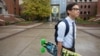 FILE - A student walks across campus at the University of Oregon in Eugene, Oregon.