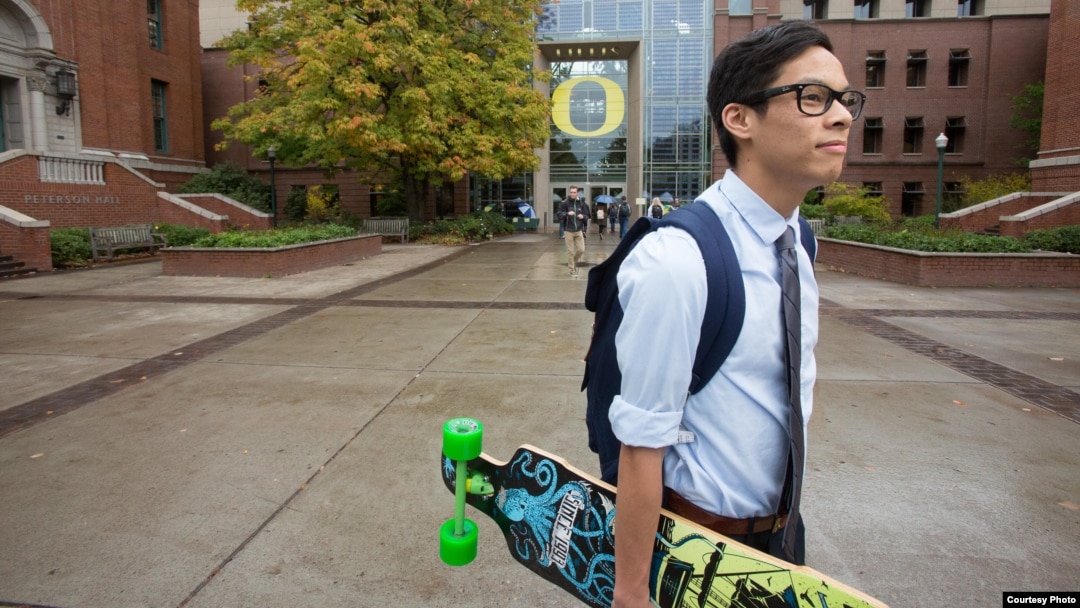 FILE - A student walks across campus at the University of Oregon in Eugene, Oregon.