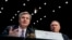 FBI Director Christopher Wray, accompanied by CIA Director Mike Pompeo, right, speaks at a Senate Select Committee on Intelligence hearing on worldwide threats, in Washington, Feb. 13, 2018. 
