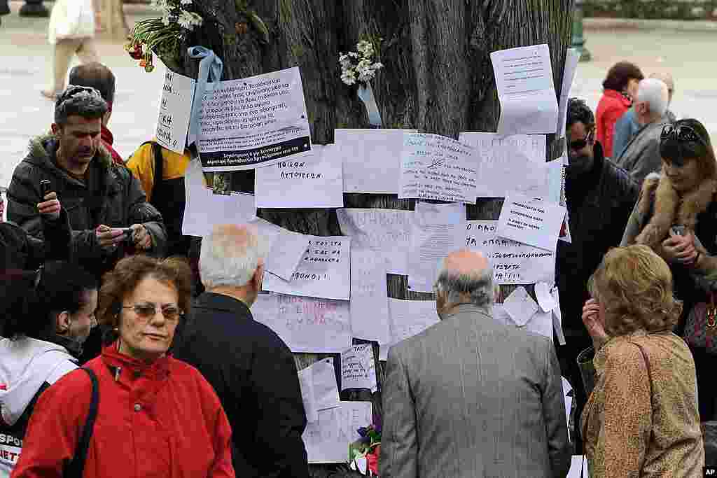 People gather at the site where an elderly man fatally shot himself at Athens' Syntagma square. (AP)