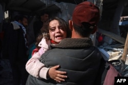 Palestinians flee their homes following Israeli bombardment in Rafah in the southern Gaza Strip on Feb. 24, 2024.