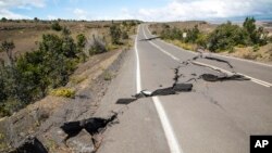 FILE - This photo provided by the National Park Service shows earthquake damage to Crater Rim Drive inside Hawaii Volcanoes National Park in Hawaii, Aug. 17, 2018. 