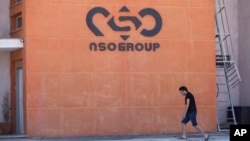 FILE - A logo adorns a wall on a branch of the Israeli NSO Group company, near the southern Israeli town of Sapir, Aug. 24, 2021.