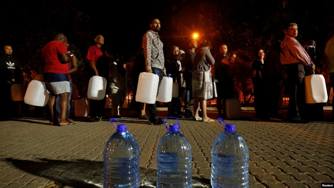 FILE - People queue to collect water from a spring in the Newlands suburb as fears over the city's water crisis grow in Cape Town, South Africa, Jan. 25, 2018.