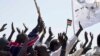 FILE - Residents wave and cheer "Bye Bye Bashir" - referring to Sudan's President Omar al-Bashir - after the result of an unofficial vote was announced in the disputed border region of Abyei, whose ownership is claimed by both Sudan and South Sudan, Oct. 31, 2013. (AP)
