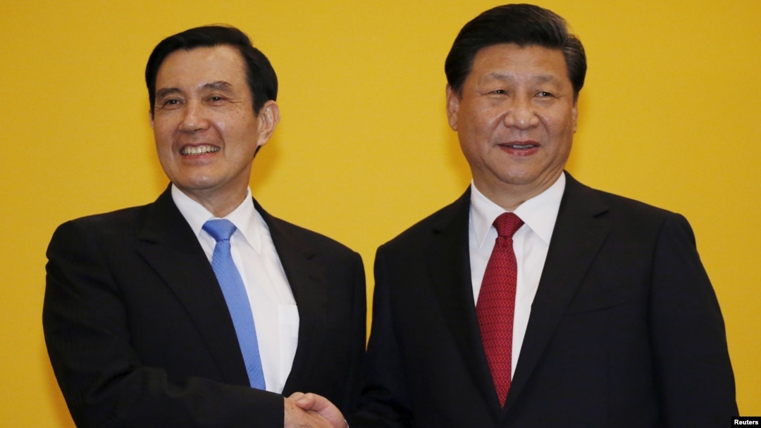 FILE - Chinese President Xi Jinping shakes hands with Taiwan's President Ma Ying-jeou during a Nov. 7, 2015, summit in Singapore. Leaders of political rivals China and Taiwan met Saturday for the first time in more than 60 years.
