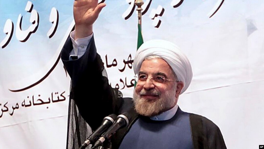 Iran's President Hassan Rouhani waves to participants while he attends a ceremony to mark the beginning of the universities academic year, at the Tehran University, in Tehran, Iran, Oct. 14, 2013. 