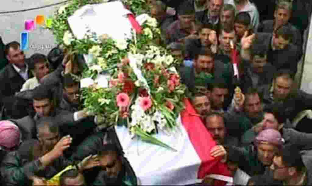 Syrian state television video footage shows mourners carrying a coffin during the funeral of two members of the security forces after they were allegedly killed by "armed groups", in Hama, north of Damascus, on April 10, 2011