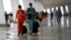  Garuda Indonesia flight attendants arrive at Terminal 3 Ultimate on the first day of its operations for domestic flights at Soekarno-Hatta Airport in Jakarta, Indonesia, Aug. 9, 2016. Female Muslim flight attendants now will have to wear headscarves on flights to and from Aceh province.
