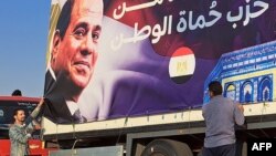 A portrait of Egypt's President Abdel Fattah el-Sisi covers the back a truck carrying aid supplies for Gaza, Oct. 16, 2023.