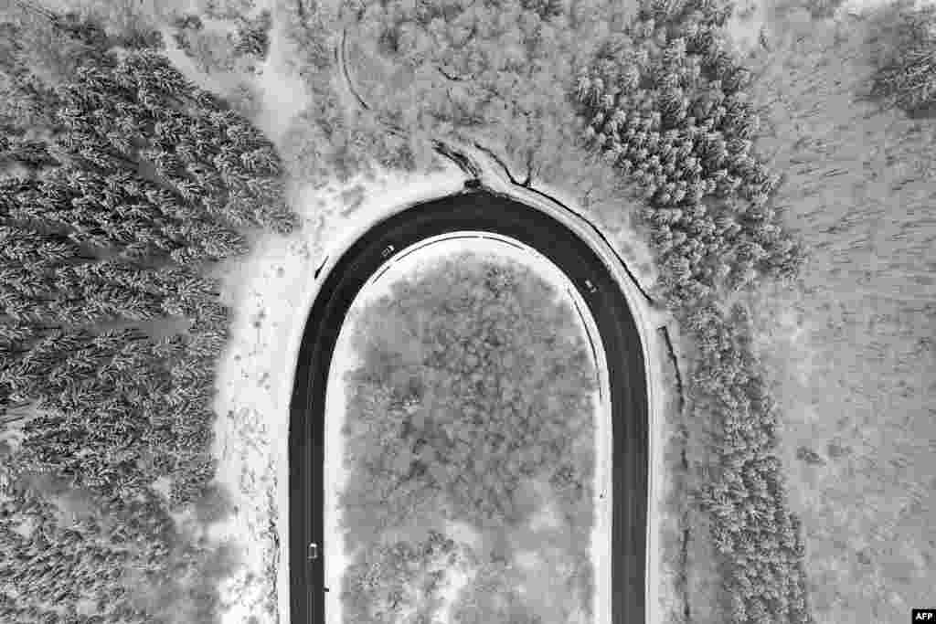 An aerial view shows cars driving on a street in a snow-covered landscape at the Nordhelle mountain near Meinerzhagen, western Germany.