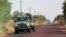 Malian soldiers drive in the direction of Diabaly, on the road near Markala, approximately 40 km outside Segou in central Mali, January 14, 2013. 