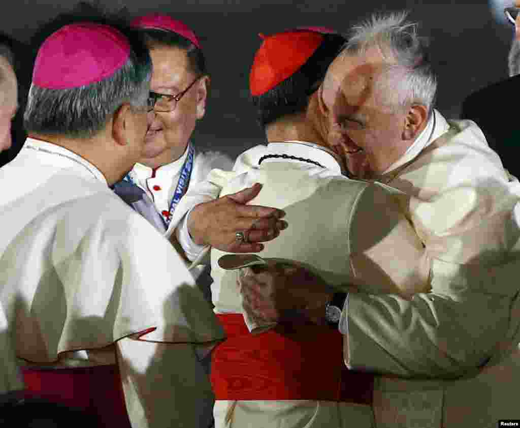 Pope Francis embraces Philippine Cardinal Luis Antonio Tagle upon his arrival at Villamor Air Base in Manila, for a state and pastoral visit, Jan. 15, 2015.