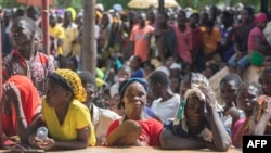 FILE —Displaced people from the province of Cabo Delgado gather to received humanitarian aid from the World Food Program (WFP) at the 21 de Abril Tribune School in the town of Namapa, Erati district of Nampula, Mozambique on February 27, 2024.