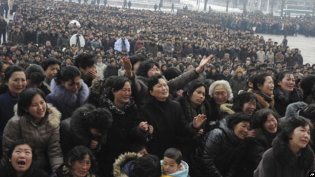 Pyongyang citizens grieve as they visit a portrait of late North Korean leader Kim Jong Il on display in the plaza of the Pyongyang Indoor Stadium in Pyongyang, North Korea, December 21, 2011.