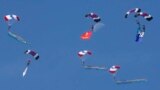 The moon is pictured as members of the Special Warfare Command parachute during a rehearsal for the upcoming anniversary of the Armed Forces Day at a military airport in Seongnam, south of Seoul, South Korea.