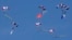 The moon is pictured as members of the Special Warfare Command parachute during a rehearsal for the upcoming anniversary of the Armed Forces Day at a military airport in Seongnam, south of Seoul, South Korea.