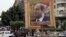  An Egyptian man on horse cart rides past a huge banner for Egypt's former army chief Abdel Fattah al-Sisi in downtown Cairo, May 6, 2014.